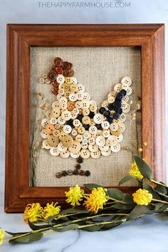 a frame with buttons and flowers in it