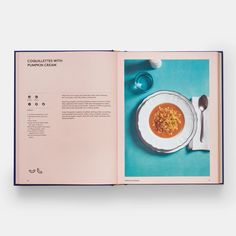 an open book with soup in it on a table