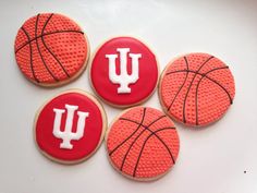 four decorated cookies in the shape of basketballs