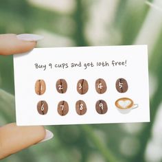 a person holding up a card that says buy 1 cups and get both free with coffee beans