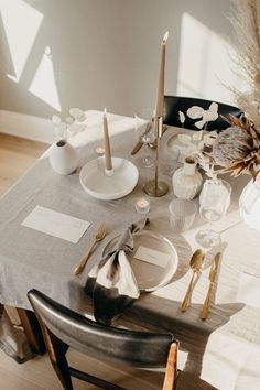 the table is set with silverware and place settings for two people to sit at