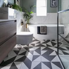 a bathroom that has a black and white checkerboard pattern on the tile floor