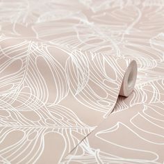 a roll of tape sitting on top of a wallpaper covered in white flowers and leaves