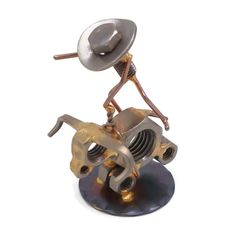 a metal figurine with a hat on top of it's head and legs