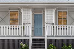 a blue front door on a white house