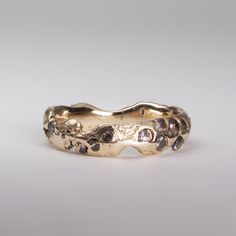 a close up of a gold ring on a white background