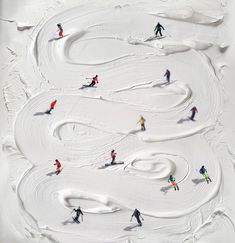 several skiers are skiing down a snow covered slope in this aerial view from above