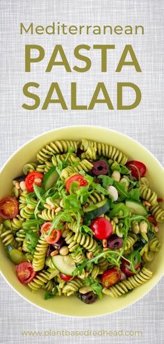 a bowl filled with pasta salad on top of a table