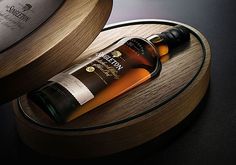 a bottle of whisky sitting on top of a wooden stand