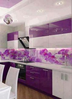 a kitchen with purple and white decor on the walls