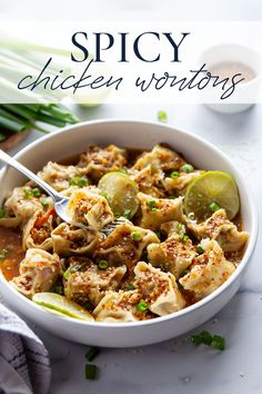 a white bowl filled with chicken wontons next to green onions and celery