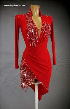 a red dress with sequins and beads on the neckline is displayed in front of a mannequin