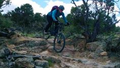 a person riding a mountain bike on a rocky trail