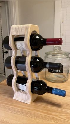 a wooden wine rack holding two bottles of wine