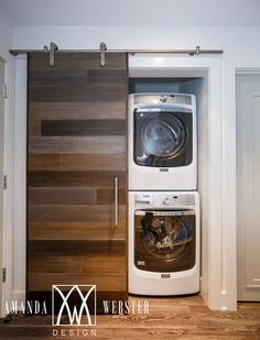 a washer and dryer in a room with wood paneling on the walls