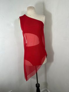 a mannequin wearing a red top with sheer fabric on it's sides