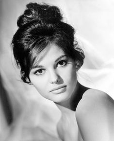 an old black and white photo of a woman with her hair in a high bun