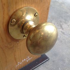 an old brass door handle on a wooden door