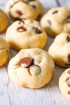 several chocolate chip cookies on a white surface