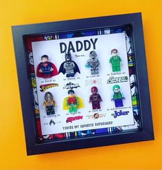 a shadow box with some legos in it and the words daddy written on it