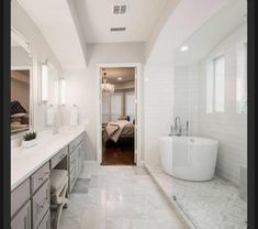 a large white bathroom with an oval tub