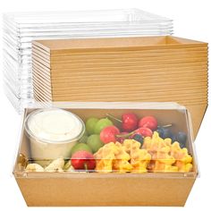 a box filled with lots of different types of fruit next to a container of yogurt