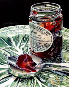 a jar filled with jelly sitting on top of a glass plate next to a spoon