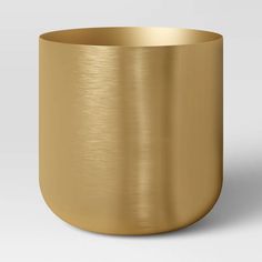 a gold metal bowl on a white background