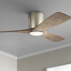 a ceiling fan in a living room with a light on the ceiling and wood blades