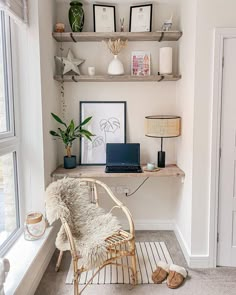 a room with a chair, desk and shelves on the wall next to a window