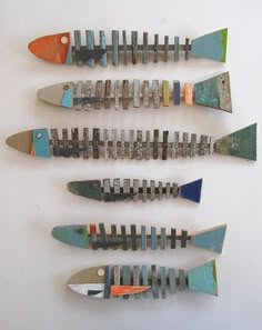 four different types of fish shaped knives on a white surface with one being cut in half and the other laying down