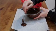 a person is dipping chocolate into a bowl