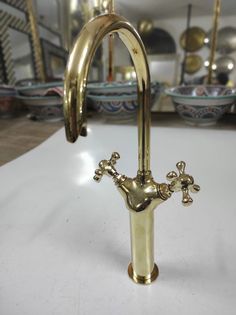 a brass faucet with two handles on a table