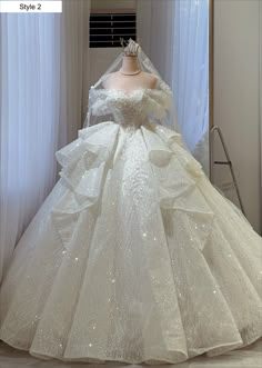 a white wedding dress on display in front of a window