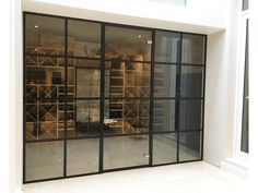 the inside of a wine cellar with glass doors