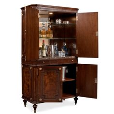 an old fashioned bar cabinet with liquor bottles and glasses