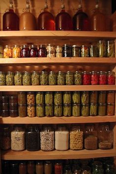 shelves filled with lots of different kinds of food in jars and jars on top of each other