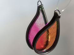 a close up of a glass ornament hanging from a hook on a string