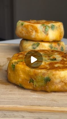 two pieces of food sitting on top of a wooden cutting board next to each other