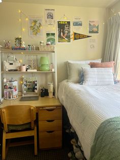 a bedroom with a bed, desk and shelves on the wall next to each other