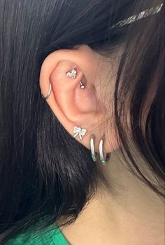 a woman with three piercings on her ear