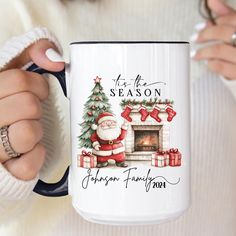 a woman holding a coffee mug with a christmas scene on it