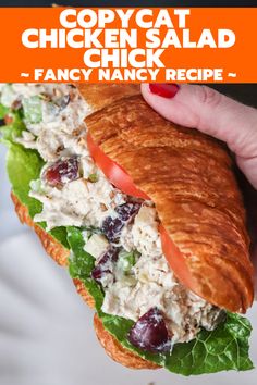 a chicken salad sandwich with lettuce, tomatoes and cranberries on it