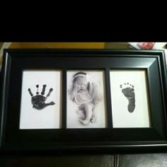 two baby hand prints in a black frame