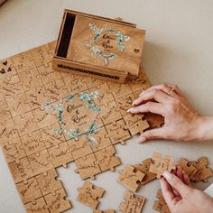 two people playing with wooden puzzles on the floor