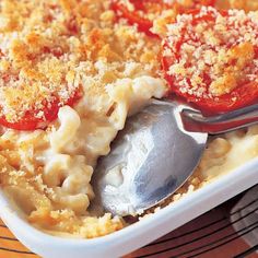 a casserole dish filled with pasta and topped with cheese, tomato sauce and parmesan bread crumbs