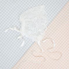 Handmade in the USA This sheer lace bonnet is the perfect accent for any special event or day! Made with the same floral netting lace as the Ella romper dress, using the scalloped edge of the lace to make a lovely frame for baby's face! Silk ribbon ties can be used to secure the bonnet on baby, and a tie on the back can be used to adjust the fit, to make it just right for her! Light ivory floral embroidered netting lace Ivory Venice lace Ivory silk satin ribbon Scalloped Lace Tulle Fabric, Lace Veil With Lace Trim For Ceremonies, Elegant Tulle Lace With Lace Trim, Elegant Lace Veil With Lace Trim, Lace Ceremony Veil With Lace Trim, Ceremony Lace Veil With Lace Trim, Ceremony Veil With Lace Trim, Fitted White Bonnet With Lace Trim, Fitted Scalloped Lace Tulle