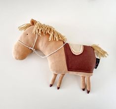 a toy horse with a saddle on it's back and manes attached to its body