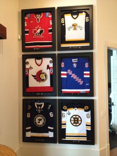 the hockey jerseys are hung up on the wall