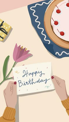 a person holding a piece of paper with the words happy birthday written on it and flowers